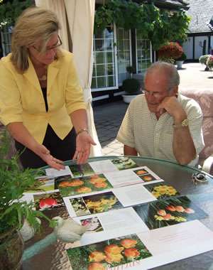 Evaleen Jaager Roy displays page proofs of her book for prominent nursery industry executive and former British Columbia Premier Bill Vander Zalm.